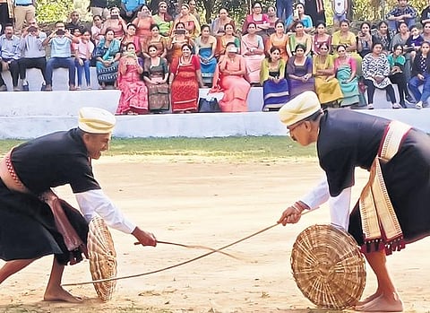 Two Kodava men perform Pare Kali 