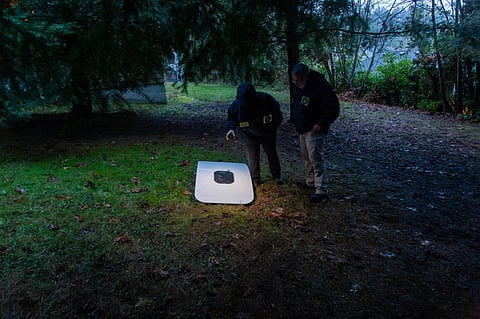This handout image released by the NTSB shows agents inspecting the door plug from Alaska Airlines Flight 1282 on January 8, 2024 after being found in Portland, Oregon. (Photo | AFP)