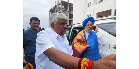 ​  JDS leader HD Revanna with Union Minister Hardeep Singh Puri  in Haradanahalli on Monday. (Photo | Express ​)