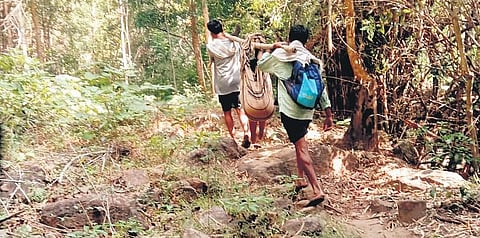 Villagers of  Ramachandrapuram are carrying a sick woman and her son in a makeshift stretcher to the hospital due to a lack of proper road connectivity 