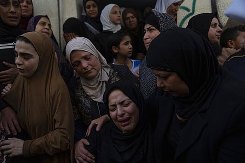 Ruby Ajouri, (C), cries after taking the last look at the body of her husband Ramzi Zabarah, 35, during his funeral in the West Bank refugee camp of Askar, near Nablus on Oct. 28, 2022. Zabarah was killed by Israeli army fire in the occupied West Bank early Friday, Palestinian health officials said. 