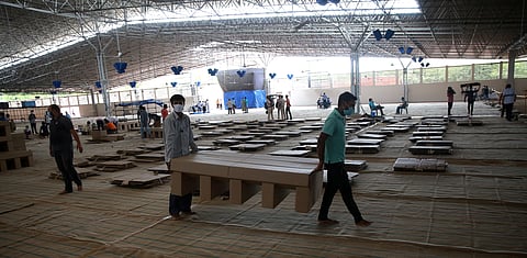 Workers carry cardboard beds after assembling as they prepare a facility that can accommodate more than ten thousand COVID-19 patients at the Radha Soami Satsang Beas complex in the Chattarpur area of New Delhi on Wednesday.  (Photo | Shekhar Yadav/EPS)
