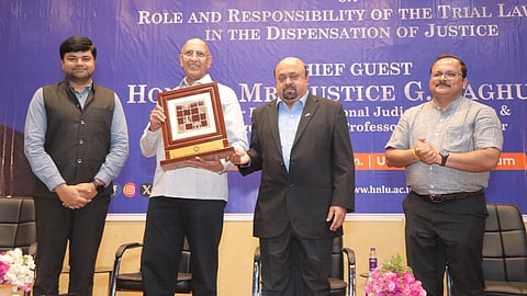 Prof Dr VC Vivekanandan presenting a memento to Justice G Raghuram at HNLU Raipur  