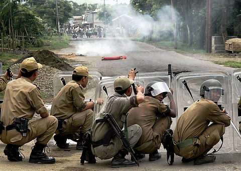 B-27, IMPHAL-040801,  AUGUST 04, 2009:  Imphal: Police fire teargas shells towards protestors during a general strike called in protest against the death of Sanjit by MPC in a fake encounter, at Khurai in Imphal on Tuesday. PTI Photo