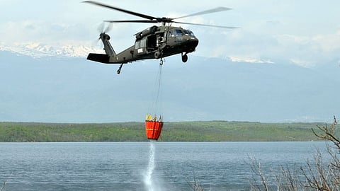 helicopter rescue forest Fire with their water bucket