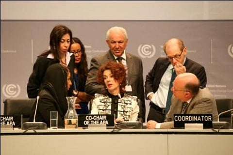Newly-elected APA co-chairs Sarah Baashan, Saudi Arabia (left), and Jo Tyndall, New Zealand (centre), speak with members of the Secretariat
Credit: IISD Reporting Services