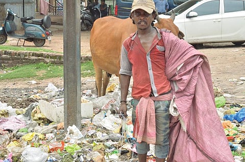 A rag picker sorts
used blood bags
at a municipal
waste dumpyard
in Dhanbad