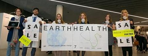 Members of civil society hold a demonstration to raise awareness about the health implications of climate change
Credit: IISD Reporting Services
