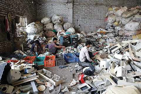 Labourers sort through plastic waste at the Tikri Kalan plastic waste depot. Most of the workers are migrants employed by local scrap dealers for about R300-400 per day (Photo: Vikas Choudhary)