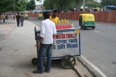 A man selling refrigerated water on Delhi’s street [image by: Chris Wilson]