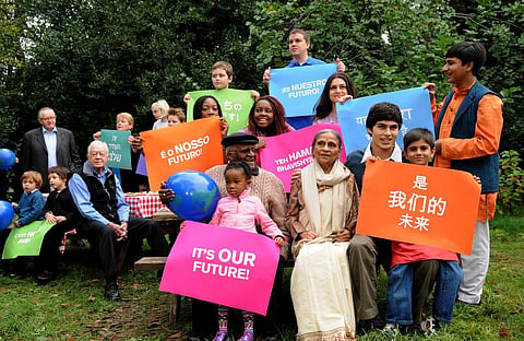 Nobel Laureate Archbishop Desmond Tutu and former US President James Earl Carter with kids displaying placards warning about climate change     Credit: Flickr