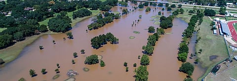 The Emission Gap Report says that the G-20, including the US and the European Union are not on track to reach their Nationally Determined Contributions by 2030. Photo of the town of Columbus, Texas flooded by Hurricane Harvey. Credit: Getty Images  