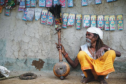 Motilal, a hermit who lives in the forests adjoining Baiga village Dhaba, flaunts his tambura, a musical instrument made from gourd. He says the soothing music of his tambura helps him unite with divinity (Photo: Vikas Choudhary)