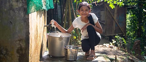 In Mon village, where water is the new luxury, a girl fills up vessels. 