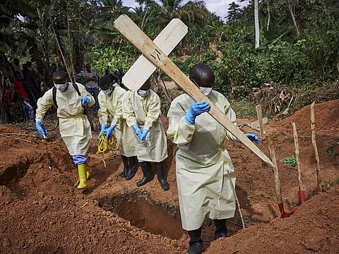 Health workers burying a child who died of Ebola in the DRC’s North Kivu province. Photo: Hugh Kinsella Cunningham/EPA