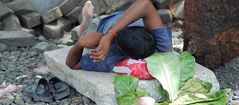 A labourer takes a nap in Mumbai. Photo: Getty Images