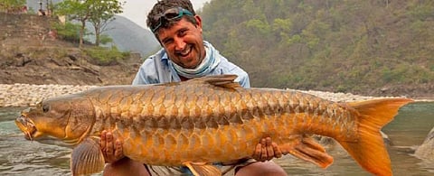Well-known UK angler, Gary Newman with a large Tor tor from Pancheswar on the Sarda River. Gary has caught and returned unharmed mahseer in excess of 40 pounds, of four different Indian species. Photo: Gary Newman