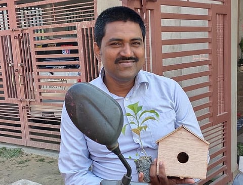 हाथ में चंपा का पौधा व गौरेया का घोंसला लेकर घर से निकलते सुशील कुमार। फोटो: शशि शेखर