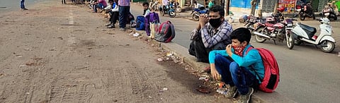Migrant workers wait near a highway in Odisha to reach their homes Photo: Ashis Senapati