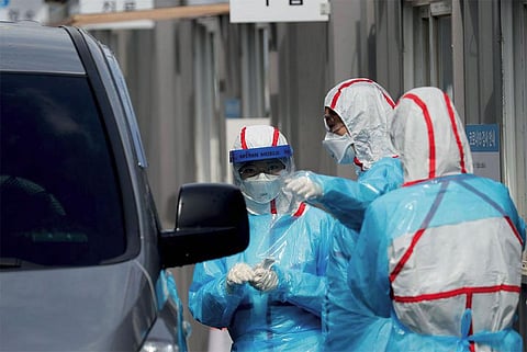 A drive-through
testing facility in
South Korea. Using
its experience from
the MERS outbreak
in 2015, the country
has not only set up a
huge infrastructure
for testing but also
kept them separate
from treatment
facilities to avoid the
spread of infection (PHOTO: REUTERS)