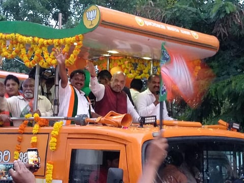 Former BJP president Amit Shah atop a campaign bus in Bengaluru’s Cambridge Layout area, campaigning for a party candidate for the 2018 Karnataka Assembly elections. Electoral expenses have been a contentious issue. Photo: Joyjeet Das 