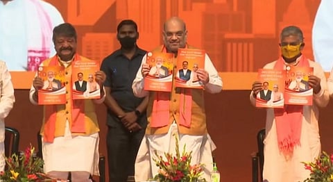 Union home minister Amit Shah releasing the BJP manifesto for West Bengal in Kolkata. Photo: Twitter account of Sunil Deodhar National Secretary, BJP