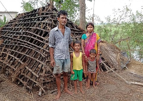 A cyclone-hit family standing in front of their damaged house in Kendrapara district. Photo: Ashis Senapati