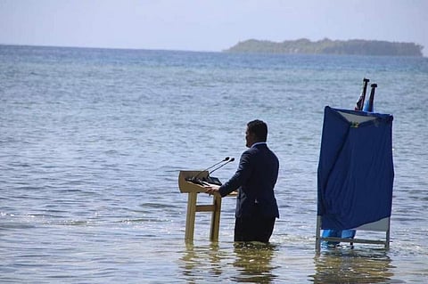 The Minister from Tuvalu in the South Pacific delivered his speech to CoP26  from the sea to illustrate the crisis they face with rising sea levels. Photo and caption: Sophie Howe / Twitter
