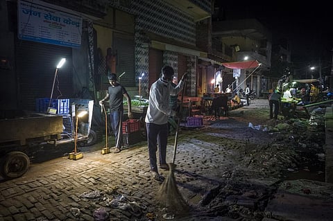 Vishal Jeenwal (26), a street sweeper, cleans the area where they have set up in Geetanjali colony, Loni, Ghaziabad, India. Photo: WaterAid / Anindito Mukherjee
