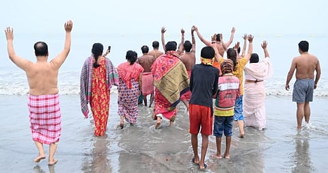 Devotees head to the sea at Sagar Island in West Bengal for a dip January 14, 2022. Photo: Jayanta Basu