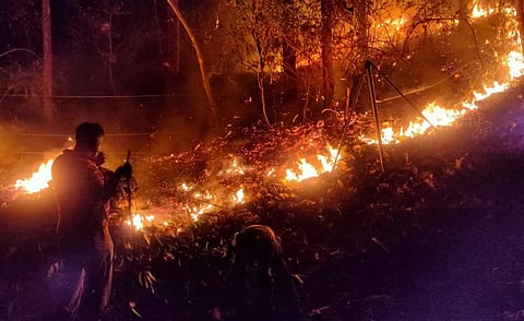 Firefighters trying to douse flames in Kerala. Photo: KA Shaji