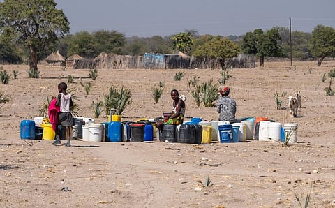 Local women filling water canisters at a well near Kapako, Namibia. Photo: iStock