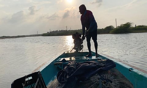 Shivajothi, a fisherman from Thazhampettai village in Tamil Nadu, steers his three-propeller fibre boat towards the open ocean. Photo: Sonikka Loganthan  
