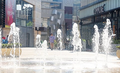 A resident walks past a fountain in China. Photo: China Xinhua news / Twitter