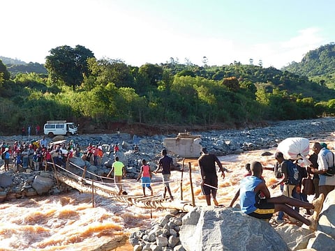 Villagers in Chimanimani district use a makeshift bridge to cross a river after Cyclone Idai washes away all bridges. Photo: Cyril Zenda
