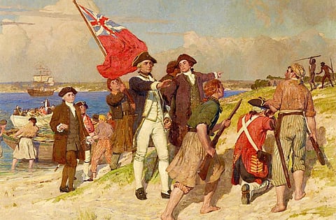 James Cook and his men land on the shores of Botany Bay on April 29, 1770. Two Aboriginal spear-wielding men are seen in the background. Painting by E Phillips Fox via Wikimedia Commons