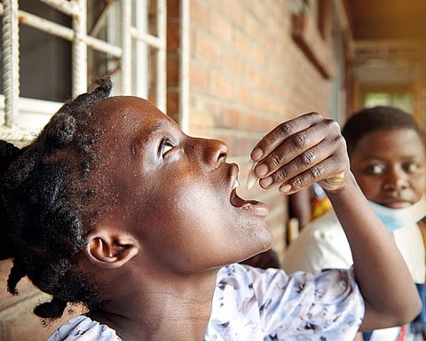 Eliza Tangwe, 18, takes a dose of oral cholera vaccine at a health centre in Blantyre, Malawi, in November 2022. The country is in the middle of its worst outbreak of the waterborne disease (Photograph: Reuters / Eldson Chagara)