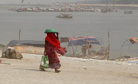 A woman walks at the Sangam in Prayagraj on a hot summer day. Photo: iStock