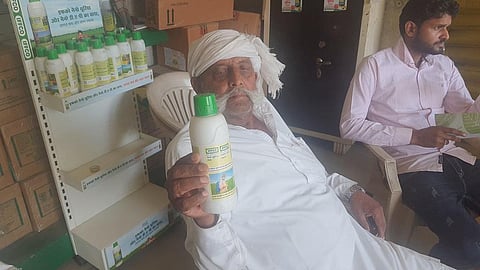 A farmer from western Uttar Pradesh with a bottle of nano liquid urea. Photo: Vivek Mishra / CSE