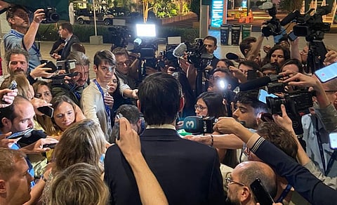 EU Commissioner for Climate Wopke Hoekstra surrounded by journalists at COP 28. Photo: @WBHoekstra / X