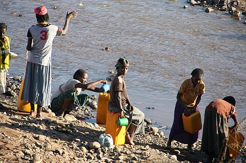Women wash clothes and take water from a river near the city of Arba Minch, Ethiopia. 