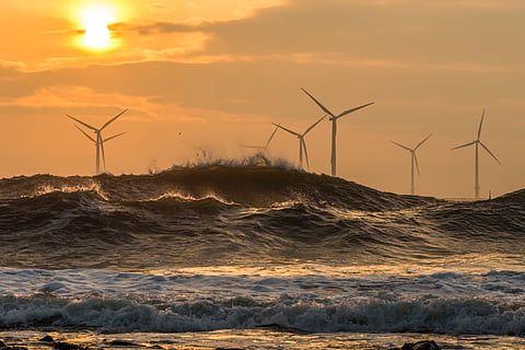 Offshore wind turbines at sunrise 