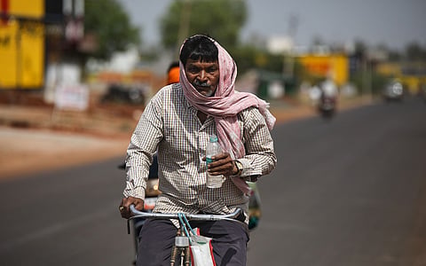 A man covers his head amid hot, dry weather in Madhya Pradesh’s Shivpuri district in 2022. 