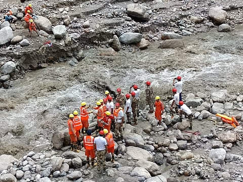 Rescue and relief workers engaged in rescue and relief work after heavy floods in Samej Khad in Rampur area of ​​​​Shimla district. 