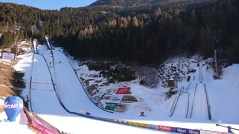 
Italy’s Predazzo Ski Jumping Stadium, which is hosting events for the 2026 Winter Olympics, needed snowmaking machines for the Italian National Championship Open on December 23, 2025.