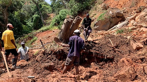 A family in Chimanimani digs on March 22, 2019, without protective clothing for their missing family member after Cyclone Idai struck the area.