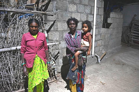 A tribal family outside their home in Mavinhalla, on the foothills of Ooty. Residents say tigers are often spotted near the village, raising concerns for the safety of people and livestock.