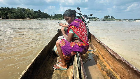 Amila, a resident of Abujhmad, travels across the Kotri river on handcrafted dongis to the local haat  in Narayanpur, Chhattisgarh, to sell a rooster. The dongis, though old and rundown, are the only way Abujhmadiya can cross the river to reach other parts of the state.