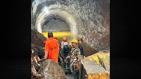 A joint Indian-Nepali team clears the blocked portion of the Chilime tunnel using excavators and loaders after flooding. Water inflow and large boulders have slowed rescue efforts.