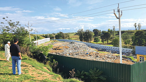 Residents of Patalbagh village in Pampore tehsil observe the landfill that has sprung near their saffron farms since 2022